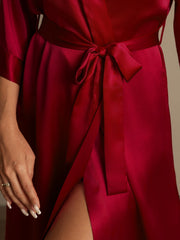 Women's mulberry silk 3/4 sleeve kimono wrap robe in rich red, tied at the waist.
