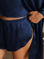 Women's navy blue mulberry silk cami shorts and robe set, showing soft fabric and elastic waistband.