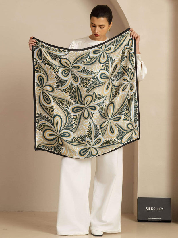 Mulberry silk abstract floral pattern square scarf, 90x90cm, held by a woman.