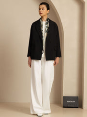 Mulberry silk abstract floral square scarf, 90x90cm, worn with a black blazer and white pants.