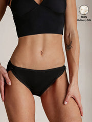 Black 100% Mulberry Silk Bikini Panty with bow detail, shown on a model.