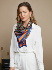 Mulberry silk bohemian square scarf with vibrant patterns and orange-blue border, styled on a woman.