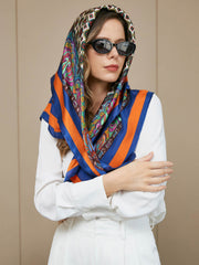 Bohemian mulberry silk square scarf with vibrant paisley and geometric patterns, blue and orange borders.