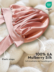 Pink mulberry silk bonnet with elastic tie straps, soft and breathable.
