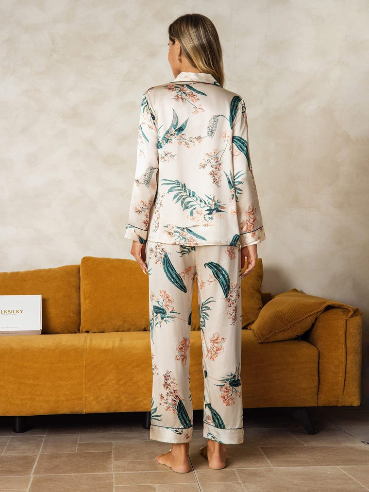 Women's mulberry silk pajamas with long sleeves and botanical print, seen from the back.