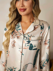Women's mulberry silk botanical print long sleeve pajamas with black piping and chest pocket.