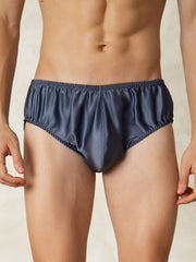 Men's grayish blue mulberry silk briefs with elastic waistband, shown on a model.