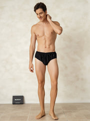 Men's black 100% mulberry silk briefs with elastic waistband, shown on a model.