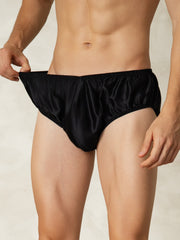 Men's black mulberry silk briefs with elastic waistband, shown on a model.