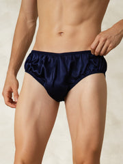 Men's dark blue 100% mulberry silk briefs with an elastic waistband, worn by a model.