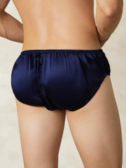 Men's navy blue mulberry silk briefs with elastic waistband, shown from the back.