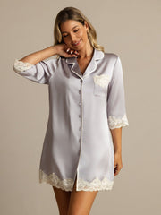 Women's mulberry silk button-up nightshirt in light gray with white lace trim on sleeves, pocket, and hem.