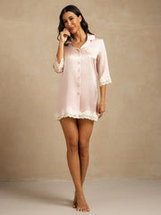 Women's pink mulberry silk button-up nightshirt with lace trim on sleeves, pocket, and hem.
