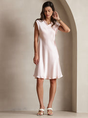 Light pink 100% mulberry silk cap sleeve V-neck knee dress on a woman.