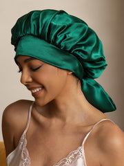 Dark green 100% mulberry silk casual bonnet with long ribbons, worn by a woman.