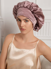 Two-tone mulberry silk bonnet in dusty rose and cream, worn by a woman with a silk camisole.