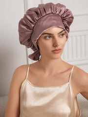 Two-tone mulberry silk casual bonnet with long ribbons, worn by a woman in a silk camisole.