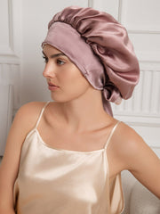Pale mauve 100% Mulberry silk casual bonnet with long ribbons, worn by a woman.