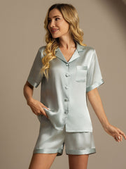 Light blue mulberry silk short sleeve women's pajama set with button-front top and shorts.