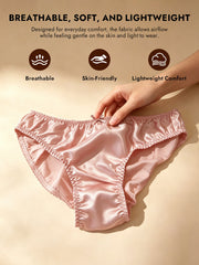 Pink mulberry silk classic bikini panty with a delicate bow, held by a hand.