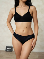 Black mulberry silk bikini panty with a small bow, worn by a woman with a matching bra.