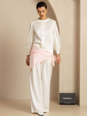 Elegant white mulberry silk top and wide-leg pants with a pink silk sash, styled on a woman.