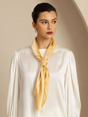 Elegant woman wearing a knotted golden yellow 100% Mulberry silk classic square scarf, 90x90cm.