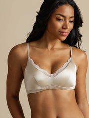 Champagne mulberry silk wireless bra with delicate lace trim, worn by a woman.