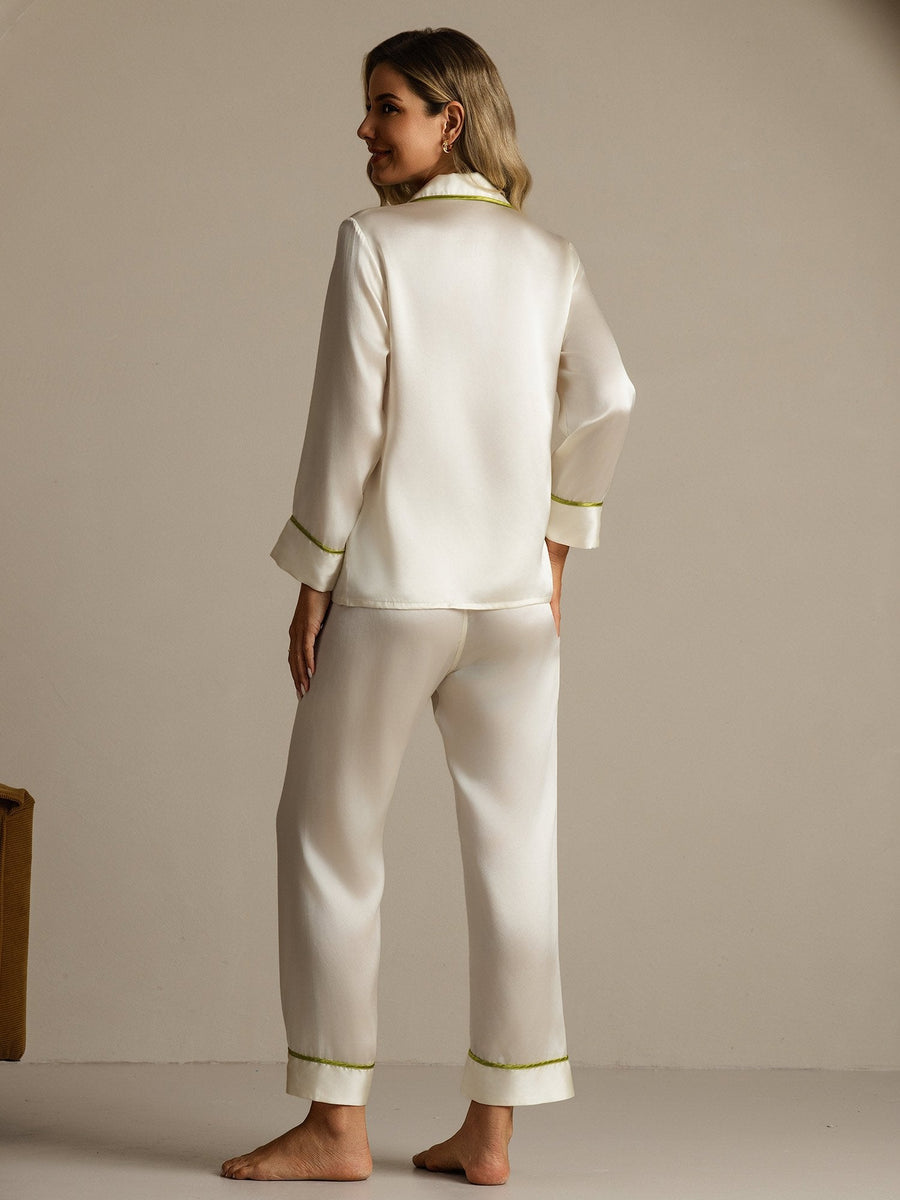 Women's ivory mulberry silk pajama set with long sleeves and green contrast piping.