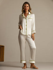 Women's ivory mulberry silk pajama set with long sleeves and green contrast piping.