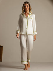 Women's white mulberry silk pajama set with long sleeves and green contrast piping.