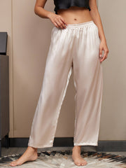 Light beige 100% mulberry silk classic women's sleep pants with an elastic waist, worn by a model.