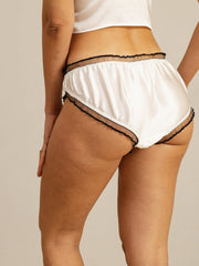 White mulberry silk comfort panty with sheer black ruffle trim.
