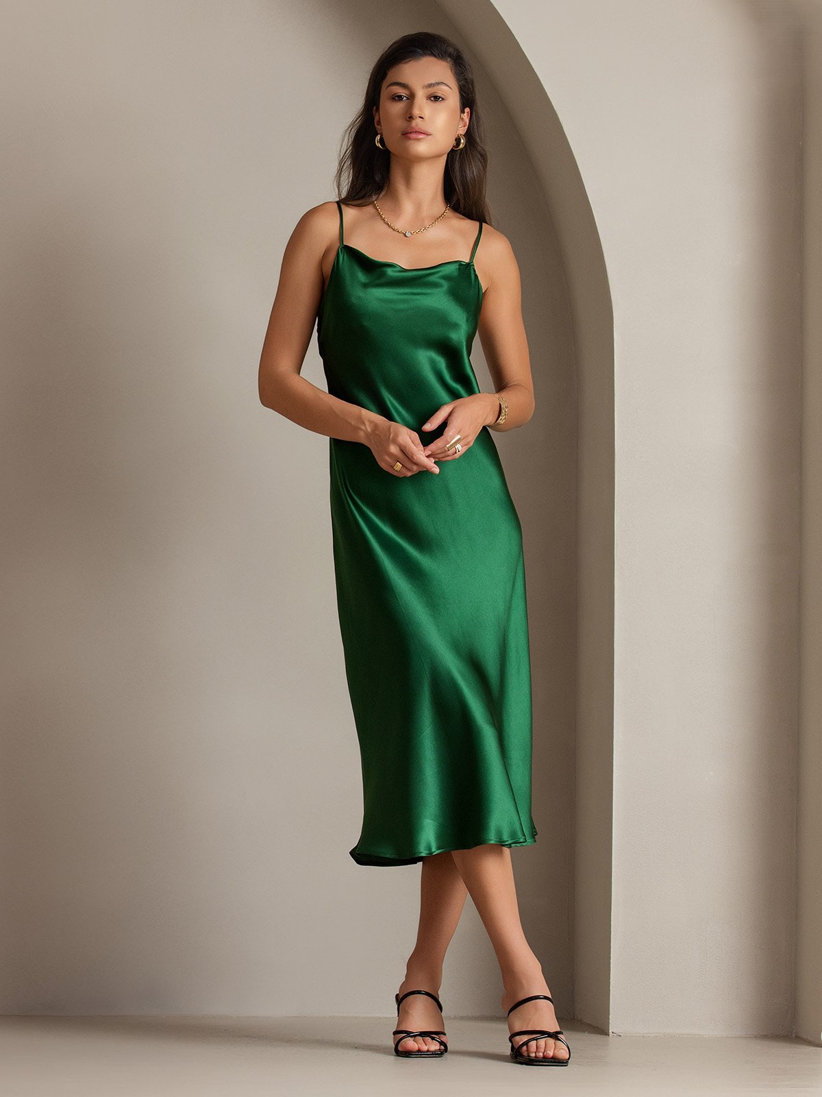 Green mulberry silk cowl neck midi dress on a woman.