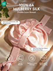 Pink 100% 6A mulberry silk double-layer bonnet with adjustable long tie, shown on a satin background.