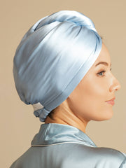 Light blue mulberry silk hair towel wrap on a woman, showing its smooth texture and gentle design.