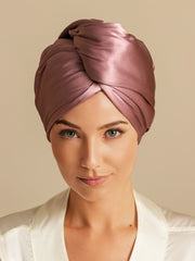 Mulberry silk hair towel wrap in a dusty rose color, twisted style, worn by a woman.