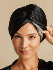 Black mulberry silk hair towel wrap on a woman, showing the soft gray inner lining.