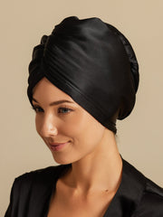 Black mulberry silk hair towel wrap on a woman, featuring a twisted turban style.