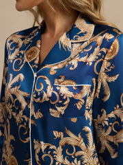 Women's mulberry silk pajamas: blue long-sleeve top with gold dragon print, notch collar, and white piping.