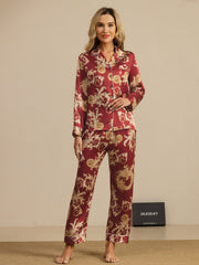 Women's mulberry silk pajamas in wine red with gold dragon print, long sleeve notch collar top, and matching pants.