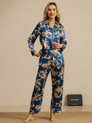 Women's navy mulberry silk pajamas with gold dragon print, long sleeves, notch collar, and white piping.