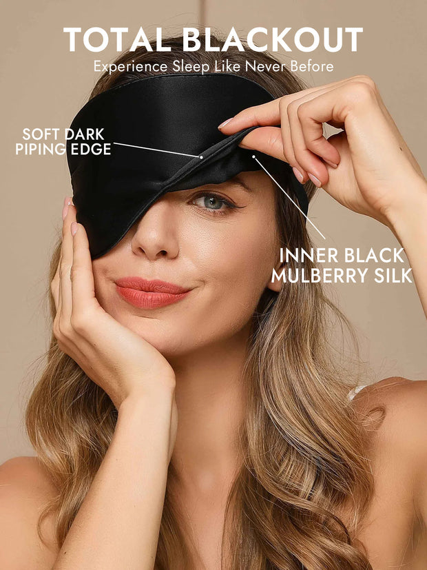 Woman wearing a black mulberry silk sleep eye mask with soft dark piping edge.