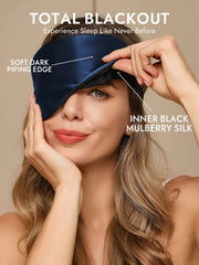 Woman wearing a navy mulberry silk sleep eye mask with soft dark piping and inner black silk.