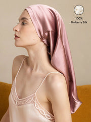 Pale mauve 100% Mulberry silk bonnet for long hair, worn by a woman, with a matching silk camisole.