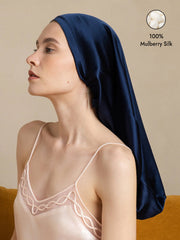 Dark blue 100% mulberry silk bonnet for long hair, worn by a woman.