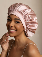 Smiling woman wearing a pink mulberry silk bonnet.