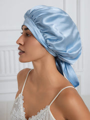 Light blue mulberry silk bonnet with long ribbons on a woman.