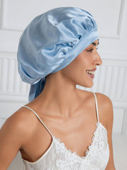 Light blue mulberry silk bonnet with long ribbons worn by a woman.
