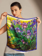 Mulberry silk floral oil painting square scarf with purple irises on a yellow background, held by a woman.